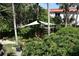 Tropical garden with a shade structure, lush plants at 1510 Ocean Shore Blvd # 4140, Ormond Beach, FL 32176