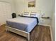 Cozy bedroom with a queen-size bed and wood floors at 1510 Ocean Shore Blvd # 4140, Ormond Beach, FL 32176