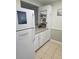 White kitchen cabinets, tile floors, and stainless steel appliances at 1510 Ocean Shore Blvd # 4140, Ormond Beach, FL 32176