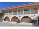 Two-story building with terracotta roof, balconies, and arched entryways at 1510 Ocean Shore Blvd # 4140, Ormond Beach, FL 32176