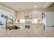 Modern kitchen with granite countertops, white cabinets, and stainless steel appliances at 4555 S Atlantic Ave # 4304, Ponce Inlet, FL 32127