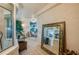 View of sunroom from entryway, showing tiled floor and mirror at 4555 S Atlantic Ave # 4304, Ponce Inlet, FL 32127