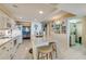 Bright kitchen boasts an island with seating, granite counters, and updated appliances at 4555 S Atlantic Ave # 4304, Ponce Inlet, FL 32127