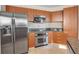 Modern kitchen with stainless steel appliances and wood cabinets at 231 Riverside Dr # 2601-1, Daytona Beach, FL 32117