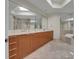 Double vanity bathroom with large mirror and marble floors at 231 Riverside Dr # 2601-1, Daytona Beach, FL 32117