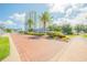 Landscaped entrance with palm trees and brick paved roadway at 231 Riverside Dr # 2601-1, Daytona Beach, FL 32117