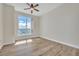 Bright bedroom with large window and ceiling fan at 231 Riverside Dr # 2601-1, Daytona Beach, FL 32117