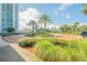 Landscaped entrance to the community with brick driveway and lush greenery at 231 Riverside Dr # 2601-1, Daytona Beach, FL 32117