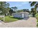 Gray house with white door and mailbox. Landscaped yard at 342 N Charles St, Daytona Beach, FL 32114