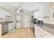 Modern kitchen with white cabinets, stainless steel appliances, and wood-look tile floors at 342 N Charles St, Daytona Beach, FL 32114