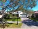 Front yard view of a house featuring a brick driveway and lush green grass at 211 Drummond Ln, Deland, FL 32724