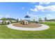 Circular playground with playset and shaded area at 137 Azure Mist Way, Daytona Beach, FL 32124