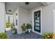 Inviting front entrance with modern door and potted plants at 137 Azure Mist Way, Daytona Beach, FL 32124