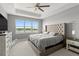 Luxurious main bedroom with water views, large windows, and a ceiling fan at 137 Azure Mist Way, Daytona Beach, FL 32124
