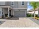 Two-car garage with paver driveway and landscaping at 137 Azure Mist Way, Daytona Beach, FL 32124