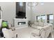 Two story living room with a modern fireplace and large windows at 137 Azure Mist Way, Daytona Beach, FL 32124