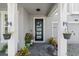 Front door entry with hanging planters and landscaping at 137 Azure Mist Way, Daytona Beach, FL 32124