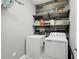 Laundry room with washer, dryer, and shelving at 137 Azure Mist Way, Daytona Beach, FL 32124