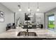 Open kitchen boasts a large island with granite countertops and stainless steel appliances at 137 Azure Mist Way, Daytona Beach, FL 32124