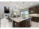Modern kitchen features dark cabinetry, granite countertops, and stainless steel appliances at 137 Azure Mist Way, Daytona Beach, FL 32124
