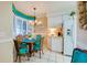 Kitchen breakfast nook with white cabinets and teal chairs at 4565 S Atlantic Ave # 5308, Port Orange, FL 32127