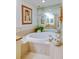 Large bathroom with a luxurious oval soaking tub and chandelier at 4565 S Atlantic Ave # 5308, Port Orange, FL 32127