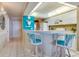 White kitchen with breakfast bar and teal accents at 4565 S Atlantic Ave # 5308, Port Orange, FL 32127