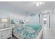 Primary bedroom with white furniture and coastal bedding at 89 S Atlantic Ave # 1002, Ormond Beach, FL 32176