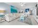 Bright living room with white sectional sofa and ocean decor at 89 S Atlantic Ave # 1002, Ormond Beach, FL 32176
