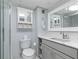 Updated bathroom with gray vanity, white toilet and walk-in shower at 89 S Atlantic Ave # 1002, Ormond Beach, FL 32176
