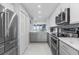 Modern kitchen with stainless steel appliances and white cabinets at 89 S Atlantic Ave # 1002, Ormond Beach, FL 32176
