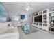 Living room features white sectional sofa and built-in shelving at 89 S Atlantic Ave # 1002, Ormond Beach, FL 32176