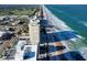 Aerial view showing beachfront building and surrounding area at 89 S Atlantic Ave # 1002, Ormond Beach, FL 32176