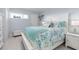 Bright bedroom with white furniture and coastal bedding at 89 S Atlantic Ave # 1002, Ormond Beach, FL 32176