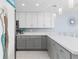 Modern kitchen with gray and white cabinets and quartz countertops at 89 S Atlantic Ave # 1002, Ormond Beach, FL 32176