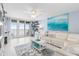 Living Room with white couch, ocean view, and coastal decor at 89 S Atlantic Ave # 1002, Ormond Beach, FL 32176