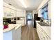 Galley-style kitchen with white cabinets and an island at 129 Blue Heron Dr # A, Daytona Beach, FL 32119