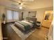 Virtually staged main bedroom with a king-size bed and ensuite bath at 129 Blue Heron Dr # A, Daytona Beach, FL 32119