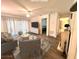 Virtually staged living room with comfortable seating and hardwood floors at 129 Blue Heron Dr # A, Daytona Beach, FL 32119