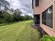 Backyard with grassy area and view of the house at 129 Blue Heron Dr # A, Daytona Beach, FL 32119