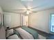 Virtually staged bedroom with a queen-size bed and wood floors at 129 Blue Heron Dr # A, Daytona Beach, FL 32119