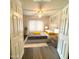 Virtually staged bedroom with a queen bed, nightstands, and ample natural light at 129 Blue Heron Dr # A, Daytona Beach, FL 32119