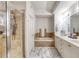 Double vanity bathroom with a soaking tub and walk in shower at 424 Luna Bella Ln # 222, New Smyrna Beach, FL 32168
