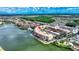 Aerial view of condo community by lake, highlighting building location and surrounding landscape at 424 Luna Bella Ln # 222, New Smyrna Beach, FL 32168