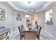 Bright dining room with glass table and marble floors at 424 Luna Bella Ln # 222, New Smyrna Beach, FL 32168