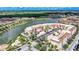 Aerial view of condo community near lake, showcasing building location and surrounding landscape at 424 Luna Bella Ln # 222, New Smyrna Beach, FL 32168
