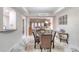 Elegant dining area with glass table, plush chairs, and marble floors at 424 Luna Bella Ln # 222, New Smyrna Beach, FL 32168