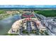 Aerial view of condo community near lake, highlighting building location and surrounding landscape at 424 Luna Bella Ln # 222, New Smyrna Beach, FL 32168