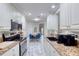 Open concept kitchen with white cabinets and breakfast nook at 424 Luna Bella Ln # 222, New Smyrna Beach, FL 32168