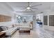 Living room with sectional sofa, TV, and marble-look floors at 424 Luna Bella Ln # 222, New Smyrna Beach, FL 32168